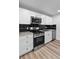 Bright modern kitchen featuring stainless steel appliances, granite countertops, and a stylish backsplash at 3220 W 8Th Ave, Denver, CO 80204