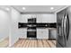 A well-lit kitchen is equipped with stainless steel appliances and dark subway tile at 3220 W 8Th Ave, Denver, CO 80204