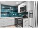 Updated kitchen showcasing stainless steel appliances, sleek cabinetry, and a vibrant backsplash at 3220 W 8Th Ave, Denver, CO 80204