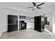 Modern kitchen with black appliances, white cabinets, and stylish light gray flooring at 3220 W 8Th Ave, Denver, CO 80204