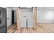 Laundry room equipped with a washer and dryer located behind a sliding barn door at 3220 W 8Th Ave, Denver, CO 80204