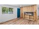Bright living room with a natural wood fireplace and large window for ample natural light at 3220 W 8Th Ave, Denver, CO 80204