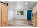 This room features new flooring, a sliding barn door, and a fireplace with a custom wood accent wall at 3220 W 8Th Ave, Denver, CO 80204