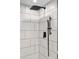 This remodeled shower features large subway tiles and black fixtures, with both a rain shower and handheld shower at 3220 W 8Th Ave, Denver, CO 80204