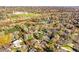 Aerial view of neighborhood and surrounding area, showcasing mature landscaping and homes at 3235 S Newland St, Denver, CO 80227