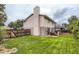 Exterior of home with a green, well-maintained backyard, including a brick and siding exterior at 3235 S Newland St, Denver, CO 80227