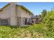 Backyard with a two-tiered deck, brick accents, a lush lawn, and privacy fencing at 3235 S Newland St, Denver, CO 80227