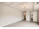 Basement featuring wood-look flooring, drop ceiling with decorative ceiling tiles and decorative light fixture at 3235 S Newland St, Denver, CO 80227