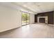 Finished basement featuring stylish flooring, brick fireplace, and sliding glass door to the outside at 3235 S Newland St, Denver, CO 80227