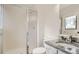 Bathroom with sliding shower door, toilet, and granite countertop vanity with faucet and mirror at 3235 S Newland St, Denver, CO 80227