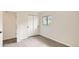 Bedroom featuring gray wood flooring, white walls, closet with sliding doors, and a window with a view to the outside at 3235 S Newland St, Denver, CO 80227