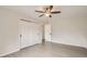 Bedroom with gray wood flooring, white walls, closet with sliding doors, ceiling fan, and view into the hallway at 3235 S Newland St, Denver, CO 80227