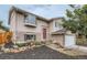 Attractive two-story home with brick accents, an inviting entrance, and meticulous landscaping at 3235 S Newland St, Denver, CO 80227