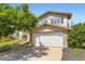 Charming two-story home with a two-car garage and mature landscaping at 3235 S Newland St, Denver, CO 80227