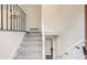 Inviting foyer with carpeted stairs, decorative railing, and neutral wall colors at 3235 S Newland St, Denver, CO 80227