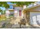 Inviting front entrance with a red door, light brick accents and rock landscaping at 3235 S Newland St, Denver, CO 80227