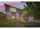 Charming home with inviting front door, landscaped yard, and a two-car garage at 3235 S Newland St, Denver, CO 80227