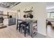 Charming kitchen features stainless steel appliances, light grey floors, and a wooden ceiling at 3235 S Newland St, Denver, CO 80227