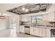 Bright kitchen boasts granite countertops, stainless appliances, and a view to the deck from the dining area at 3235 S Newland St, Denver, CO 80227
