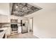 Stylish kitchen showcasing stainless appliances, granite countertops, and a distinctive ceiling design at 3235 S Newland St, Denver, CO 80227