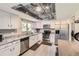 Modern kitchen featuring white cabinets, stainless steel appliances, and stylish countertops at 3235 S Newland St, Denver, CO 80227