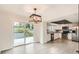 Bright eat-in kitchen with sliding doors to deck, stainless appliances, and modern light fixtures at 3235 S Newland St, Denver, CO 80227
