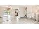 Open-concept living area featuring stylish flooring and large sliding glass doors leading to outdoor deck at 3235 S Newland St, Denver, CO 80227