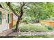 Serene backyard featuring lush lawn, stone path, mature trees, and privacy fencing at 3346 W 30Th Ave, Denver, CO 80211