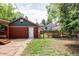 View of backyard features a detached garage with fenced in pet run and grass area at 3346 W 30Th Ave, Denver, CO 80211