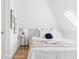 Bright bedroom featuring a bedside table, decor and comfortable bed with many pillows at 3346 W 30Th Ave, Denver, CO 80211