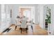Charming dining area featuring a modern light fixture, hardwood floors, and natural light from the windows at 3346 W 30Th Ave, Denver, CO 80211