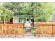 Charming brick home with a cozy front yard, featuring a picket fence and mature tree at 3346 W 30Th Ave, Denver, CO 80211