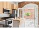 Bright kitchen featuring stainless steel appliances, light wood cabinets and access to the deck at 3346 W 30Th Ave, Denver, CO 80211