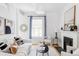 Bright and airy living room with a fireplace, white walls, and contemporary decor at 3346 W 30Th Ave, Denver, CO 80211