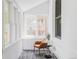 Bright sunroom with multiple windows, white brick walls, and stylish decor at 3346 W 30Th Ave, Denver, CO 80211