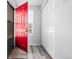 Bright foyer featuring a vibrant red door, closet, and modern flooring, creating a welcoming entrance at 8462 Everett Way # B, Arvada, CO 80005