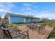 Backyard featuring a detached home, stone sitting area with furniture, and healthy green grass at 2166 S Golden Ct, Denver, CO 80227