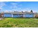 Large backyard featuring a detached home and a healthy green lawn for recreational outdoor activities at 2166 S Golden Ct, Denver, CO 80227