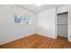 Cozy bedroom with a window and natural wood flooring and a closet at 2166 S Golden Ct, Denver, CO 80227
