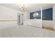 Bright dining room features tile flooring, a modern chandelier, and a decorative blue accent wall at 2166 S Golden Ct, Denver, CO 80227
