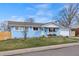 Charming, blue ranch-style home with a manicured lawn, two-car garage and inviting front porch at 2166 S Golden Ct, Denver, CO 80227