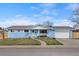 Charming, blue ranch-style home with a manicured lawn, two-car garage and inviting front porch at 2166 S Golden Ct, Denver, CO 80227