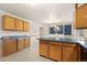 Open concept kitchen with wood cabinets and a view into the dining room at 2166 S Golden Ct, Denver, CO 80227