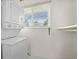 Laundry room with stackable washer/dryer and a bright window at 2166 S Golden Ct, Denver, CO 80227