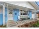 Inviting front porch with a decorative railing and comfortable seating on a blue painted home at 2166 S Golden Ct, Denver, CO 80227