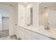 Elegant bathroom features a double vanity, quartz countertops, modern fixtures, and tile flooring at 2050 S Haleyville Way, Aurora, CO 80018