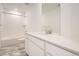 Bright bathroom features a single vanity, quartz countertops, modern fixtures, and tile flooring at 2050 S Haleyville Way, Aurora, CO 80018