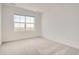 Neutral bedroom features plush carpet, ample natural light from a large window, and fresh paint at 2050 S Haleyville Way, Aurora, CO 80018