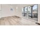 Bright living area with wood floors and sliding glass doors leading to a patio at 2050 S Haleyville Way, Aurora, CO 80018