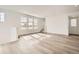 Open living room with hardwood floors, large windows, and neutral color scheme at 2050 S Haleyville Way, Aurora, CO 80018